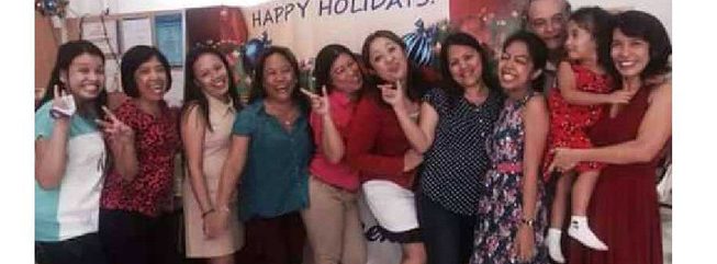 The RJ Agency team celebrating together at a holiday gathering, with founders Richard and Jenny